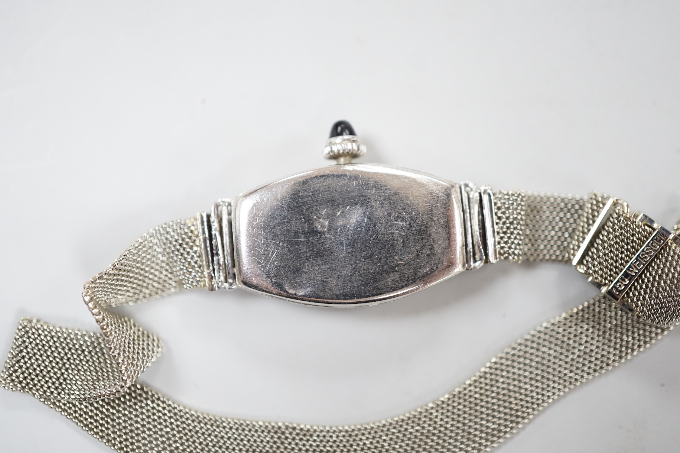 An Art Deco white metal (stamped platine) black onyx and diamond cluster set cocktail watch, on a 750 white mesh bracelet, approx. 16cm, gross weight 18.7 grams.